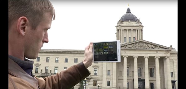 A man uses the Asus ZenPad S 8.0 to take a picture of a building with its different camera features.