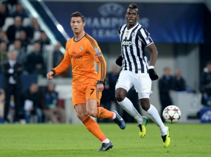 Juventus midfielder Paul Pogba (L) competes with Real Madrid's Cristiano Ronaldo.