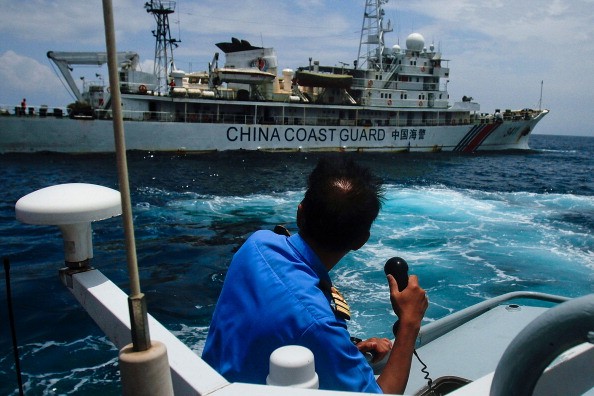  A Malaysian Navy officer makes a call as their ship approaches a Chinese Coast Guard ship in the South China Sea on March 15, 2014 in Kuantan, Malaysia.