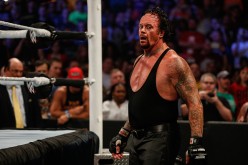 The Undertaker tries to catch his breathe during a match against Brock Lesnar.