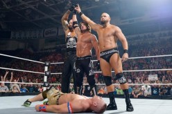 A.J. Styles, Luke Gallows and Karl Anderson are standing tall over the beaten John Cena.