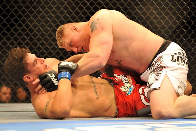 Brock Lesnar holds down Frank Mir during their heavyweight title bout during UFC 100 on July 11, 2009 in Las Vegas, Nevada.