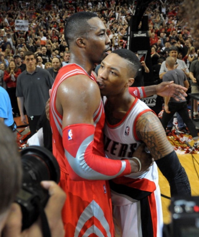 Houston Rockets center Dwight Howard (L) embraces Portland Trail Blazers' Damian Lillard after a playoffs series.