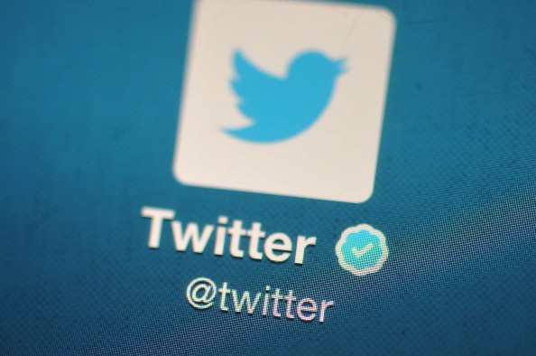 Twitter logo is displayed on a screen of a mobile device.