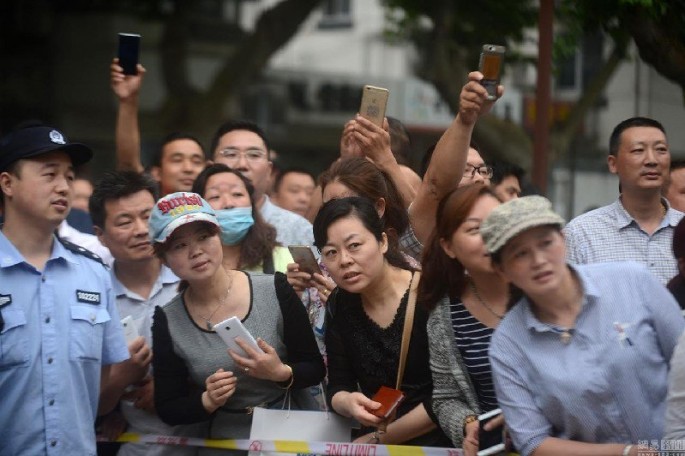 Parents waiting for their children taking the gaokao, or the Chinese national college admissions exams. The exams are known not only for being hard, but also for having very strict rules.