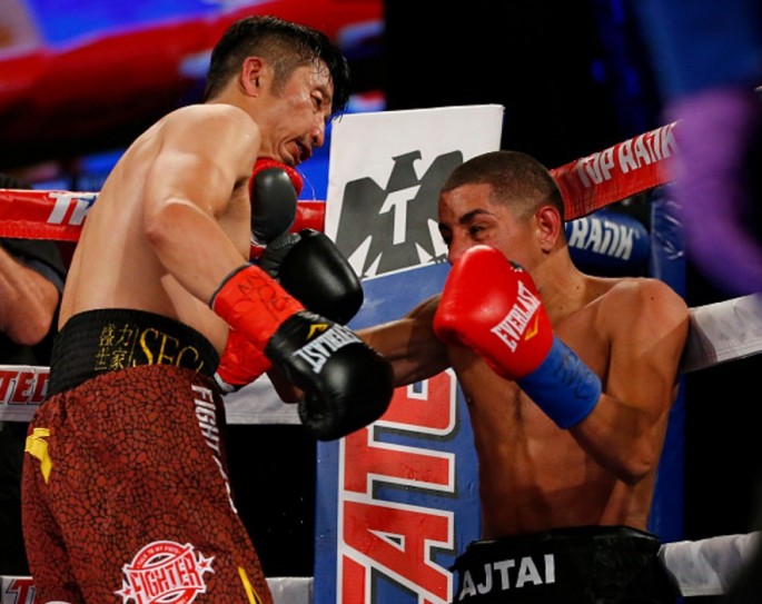 Chinese boxing star Zou Shiming (L) overpowers Hungary's Jozsef Ajtai.