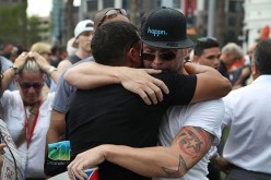 People hug as they stand together during a memorial service at the Dr. Phillips Center for the Performing Arts for the victims of the Pulse gay nightclub shooting, June 13, 2016, Orlando, Florida. 