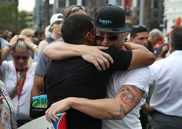 People hug as they stand together during a memorial service at the Dr. Phillips Center for the Performing Arts for the victims of the Pulse gay nightclub shooting, June 13, 2016, Orlando, Florida. 