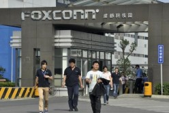 Workers walk away from a Foxconn factory in Chengdu, Sichuan Province.