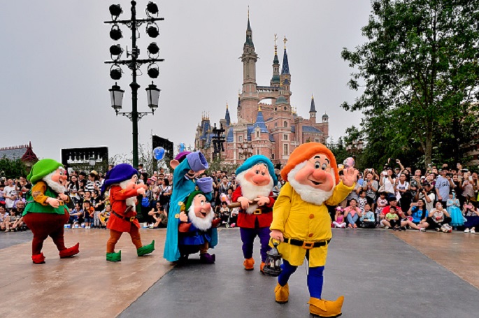Where’s Snow White? Some of the seven dwarves greet visitors during a trial run of Shanghai Disney Resort on June 11 in Shanghai, China. 