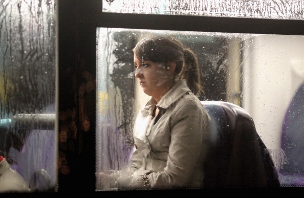 A woman looking depressed sits on a bus as it makes its way along St Vincent Street on November 1, 2010 in Glasgow, Scotland.