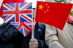 A Chinese man holds British and Chinese flags on Nov. 9, 2005, in London, England. 