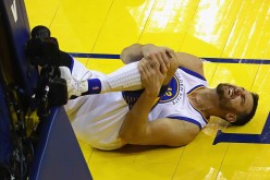 Andrew Bogut #12 of the Golden State Warriors reacts after suffering an apparent injury during the second half against the Cleveland Cavaliers in Game 5 of the 2016 NBA Finals at ORACLE Arena on June 13, 2016 in Oakland, California.