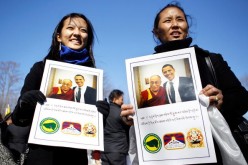 Tenzin Lhamo (L) and her mother Dolma Kyizom (R) of New York City hold a picture of the Dalai Lama and U.S. President Barack Obama as Tibetans gather outside the White House Feb. 18, 2010 in Washington, DC. 