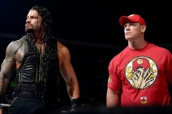 Roman Reigns and John Cena are standing in the ring ready for action.