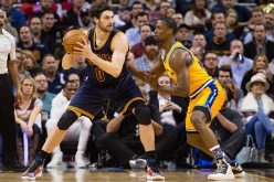 Kevin Love of the Cleveland Cavaliers is posting up Harrison Barnes of the Golden State Warriors during a game.