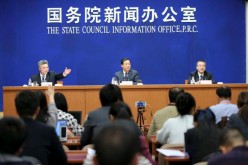 Officials from China National Space Administration answer queries during a press conference in Beijing in April.