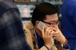 A Chinese man making a call with his iPhone 6 Plus inside an Apple store on Oct. 17, 2014, in Beijing, China.