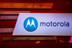 A logo sits illuminated outside the Motorola pavilion during the second day of the Mobile World Congress 2015