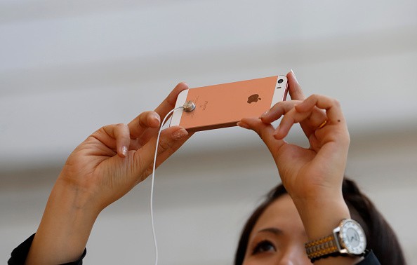 A member of the media tries an Apple Inc. iPhone SE at the company's Omotesando store on March 31, 2016 in Tokyo, Japan.