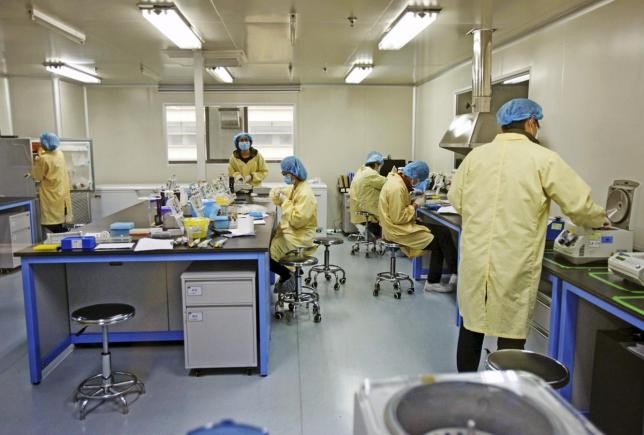 Researchers work at a genomics laboratory in Tianjin.