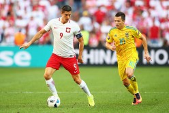 Poland striker Robert Lewandowski (L) competes for the ball against Ukraine's Yevhen Konoplyanka.