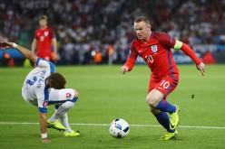 England captain Wayne Rooney dribbles past Slovakia's Peter Pekarik.