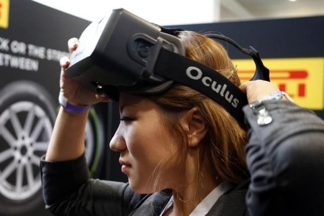 A woman tries a virtual reality (VR) headset at a product show and exhibition.