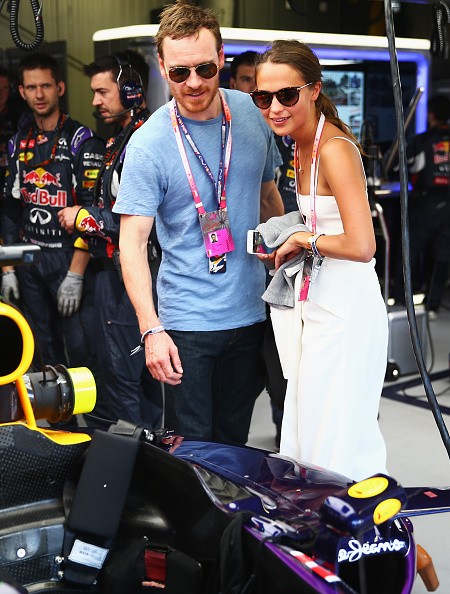 Actors Alicia Vikander and Michael Fassbender are seen in the Infiniti Red Bull Racing team garage before the Monaco Formula One Grand Prix at Circuit de Monaco on May 24, 2015 in Monte-Carlo, Monaco.