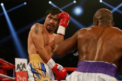 Manny Pacquiao (L) avoids a punch from Timothy Bradley Jr. during their welterweight championship fight on April 9, 2016 at MGM Grand Garden Arena in Las Vegas, Nevada.