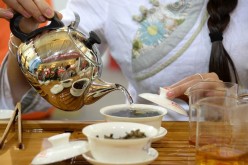 A tea art specialist makes tea during the Beijing International Tea Expo 2016, June 24, 2016. 