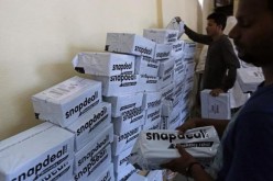 Employees of Snapdeal, an Indian online retailer, check packages for delivery in an office in Mumbai.