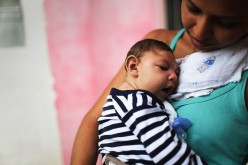 Mother Daniele Santos holds her baby Juan Pedro, who has microcephaly, on May 30, 2016 in Recife, Brazil. 