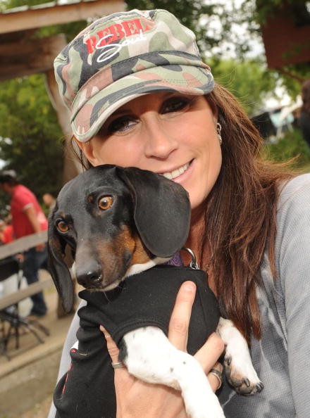 Singer/Songwriter Terri Clark, and dog Rudy pose backstage at the 17th Annual Country Thunder USA music festival on July 18, 2009 in Twin Lakes, Wisconsin. 