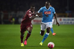 Napoli defender Kalidou Koulibaly (R) competes for the ball against Torino's Afriyie Acquah.