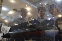Sailors look at a model of a submarine to be delivered to Vietnam.