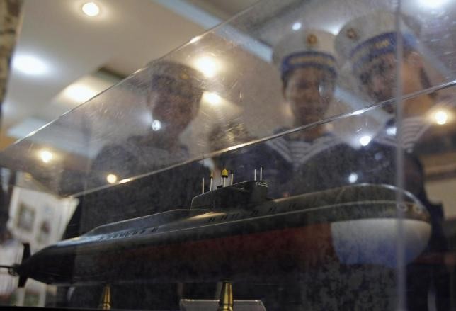 Sailors look at a model of a submarine to be delivered to Vietnam.