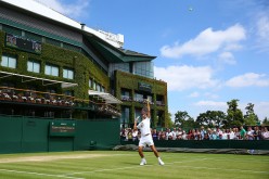 Roger Federer of Switzerland serves during practice on day ten of the Wimbledon Lawn Tennis Championships at the All England Lawn Tennis 