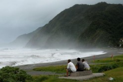 Men watch waves crash at the coast as Typhoon Nepartak approaches in Yilan, Taiwan, July 7, 2016.