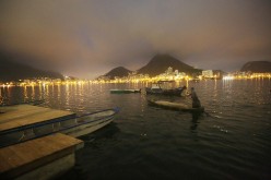 A fisherman paddles in the polluted Rodrigo de Freitas Lagoon, venue for the rowing events at the Rio 2016 Olympic Games, on July 1, 2016 in Rio de Janeiro, Brazil. 