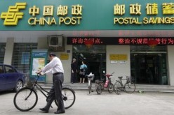 Customers leave a branch of Postal Savings Bank of China in Wuhan, Hebei Province.