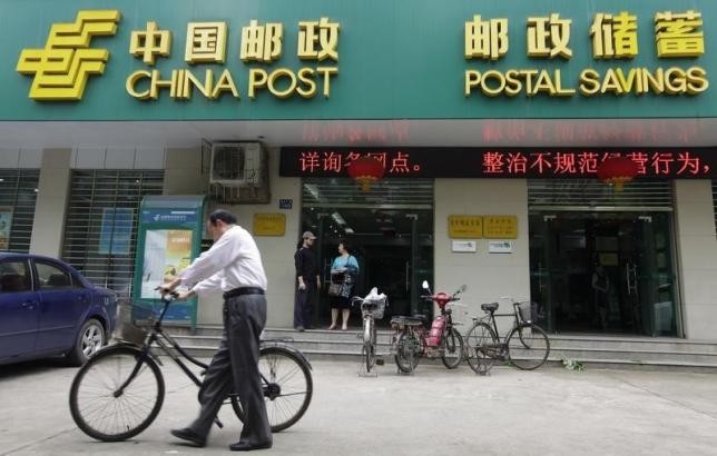 Customers leave a branch of Postal Savings Bank of China in Wuhan, Hebei Province.