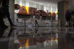 Employees walk past the lobby of Alibaba headquarters in Hangzhou, Zhejiang Province.