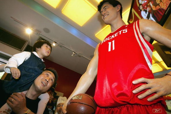 A visitor and his daughter view the waxwork of NBA star Yao Ming at Madame Tussauds Shanghai on May 1, 2006, in Shanghai, China.