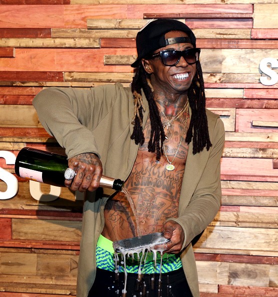 Rapper Lil Wayne pours champagne over his Samsung Galaxy S7 at Samsung Galaxy Life Fest at SXSW 2016 on March 12, 2016 in Austin, Texas.