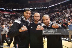 Tim Duncan (left) and teammates Manu Ginobili and Tony Parker show off their championship rings after winning the 2014 NBA title.