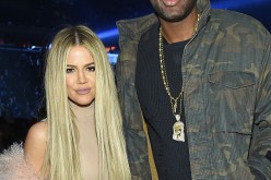 Khloe Kardashian's ex Lamar Odom fights with photographer after being spotted at strip bar.