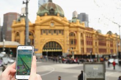 Tristan plays the Pokemon Go game on his phone in front of Flinders Street Station on July 13, 2016 in Melbourne, Australia. 