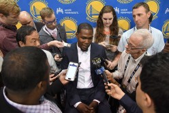  Kevin Durant speaks to the media during the press conference where he was introduced as a member of the Golden State Warriors after they signed him as a free agent on July 7, 2016 in Oakland, California.