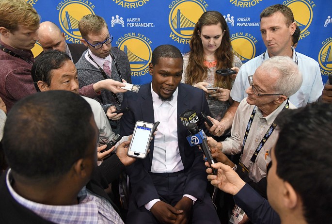  Kevin Durant speaks to the media during the press conference where he was introduced as a member of the Golden State Warriors after they signed him as a free agent on July 7, 2016 in Oakland, California.